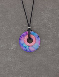 picture of alcohol ink necklace in blue on round disc